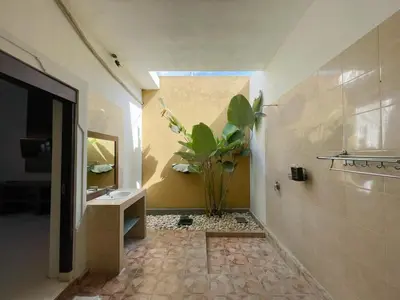 a bathroom with a sink and a potted plant at The Lavana Bali Radiance Arjuna Villa Seminyak in Seminyak