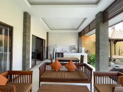 a living room with a couch and a table at The Lavana Bali Radiance Arjuna Villa Seminyak in Seminyak