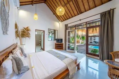 a bedroom with a large bed and a pool at villa mangga 2 chambres seminiak in Seminyak