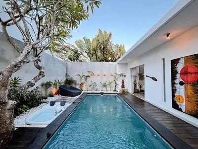 an infinity pool in the backyard of a house at Modern 2 BR villa seminyak center. in Seminyak