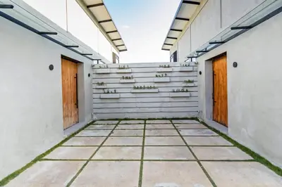 an empty corridor of a building with two doors at Manresa Villa Bali 1 in Canggu
