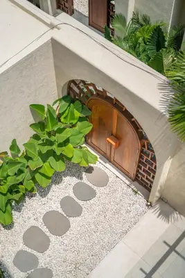 a dog house with a brick oven in a yard at Alegria de la Vida in Canggu