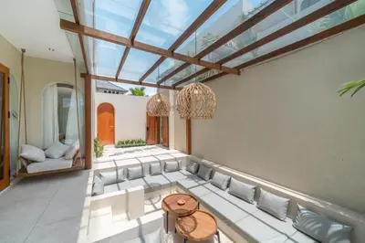 a living room with a couch and a glass ceiling at Alegria de la Vida in Canggu