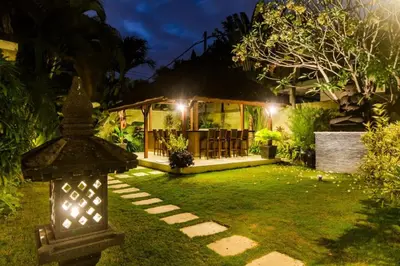 a house with a light in the yard at night at Luxury Villa AnTan Central Seminyak in Seminyak
