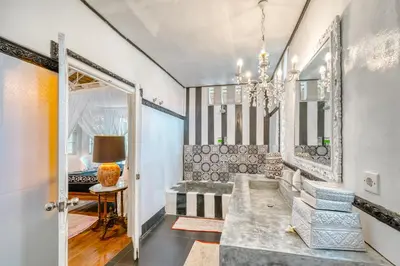 a room with a hallway with a mirror and a table at Villa Kalis, 10 BR family and group Villa in Seminyak