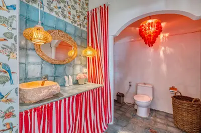 a bathroom with a tub and a sink and a toilet at Villa Kalis, 10 BR family and group Villa in Seminyak