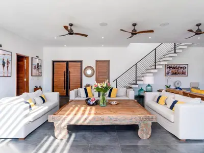 a living room with two couches and a coffee table at Villa Sanya Berawa in Canggu