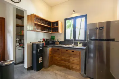 a kitchen with a stainless steel refrigerator and a sink at Villa Sanya Berawa in Canggu