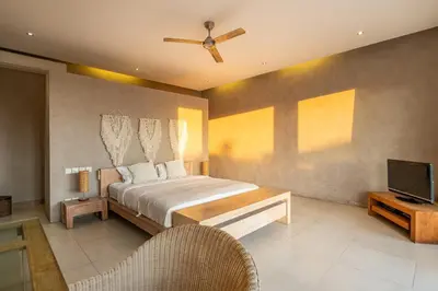 a bedroom with a bed and a flat screen tv at Spacious and Stylish Villa 3 Bedroom Seminyak in Denpasar