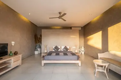 a bedroom with a bed and a ceiling fan at Spacious and Stylish Villa 3 Bedroom Seminyak in Denpasar