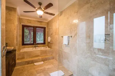 a large bathroom with a shower and a sink at Beautiful & Luxurious 3-Bedroom Private Villa With Pool 150-Metres To Seminyak Beach in Seminyak