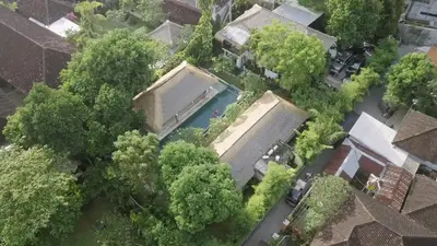 an overhead view of a house with a swimming pool at Blind Dog Inn in Sanur