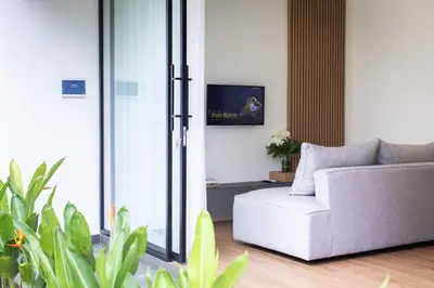 a living room with a couch and a tv at 20 Suites Umalas in Canggu