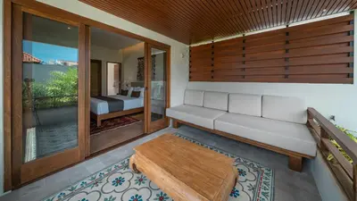 a living room with a bench and a table at Villa Emmy by Elite Havens in Seminyak