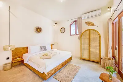 a bedroom with a large white bed and a window at NEW Fresh 3BD Prime Location Villa in Seminyak