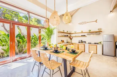 a kitchen with a large wooden table and chairs at NEW Fresh 3BD Prime Location Villa in Seminyak