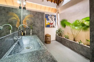 a bathroom with a large tub with plants at Villa Fendi Seminyak in Seminyak