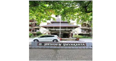 a white car parked in front of a building at The Palmana Tropical Roofline Jayakarta Residence 50 in Legian