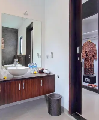 a bathroom with a sink and a mirror at Agata Villas Seminyak in Seminyak