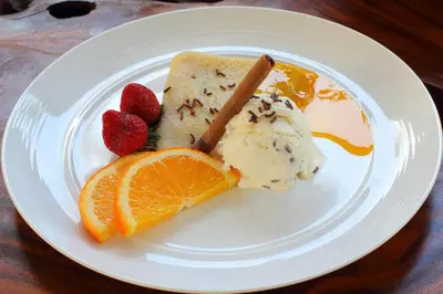 a plate of food with ice cream and fruit at Agata Villas Seminyak in Seminyak