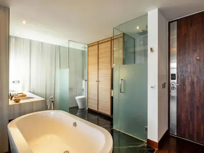 a bathroom with a tub and a sink at The Isvara by Cove in Seminyak