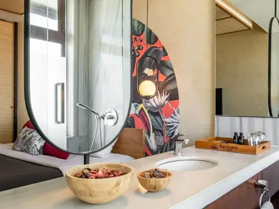 a bathroom with a sink and a mirror at The Isvara by Cove in Seminyak