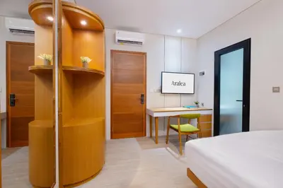 a hotel room with a bed and a desk at Aralea Coliving in Denpasar