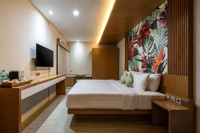 a hotel room with a bed and a tv at Aralea Coliving in Denpasar