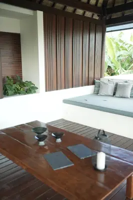a living room with a table and a bed at VILLA CELAVI 15 in Kerobokan