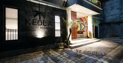 a building with a sign on the side of it at Keola Hotel Legian in Legian