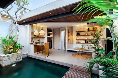 a pool in the middle of a house with plants at Danu Villas Bali in Kerobokan