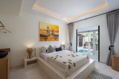 a bedroom with a bed and a large window at Villa Matahari - Seminyak in Seminyak