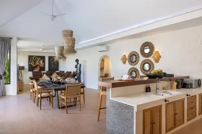 a kitchen and living room with a table and chairs at Villa Matahari - Seminyak in Seminyak