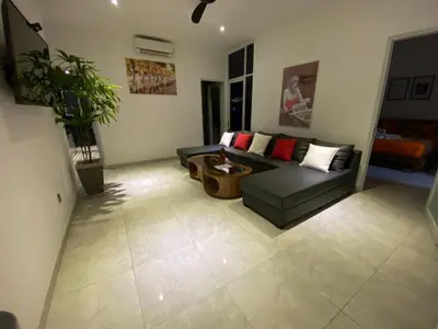 a living room with a couch and a table at Villa Mabuk in Legian