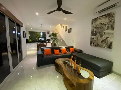 a living room with a couch and a table at Villa Mabuk in Legian