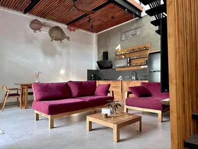a living room with purple couches and a table at LINDT - Bali Invest Club in Dalung