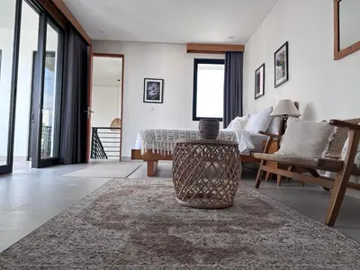 a living room with a bed and a table at LINDT - Bali Invest Club in Dalung