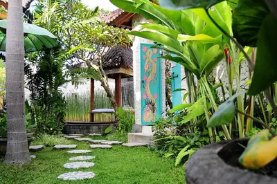 a garden with a pathway in front of a house at Villa Domus De Janas in Seminyak