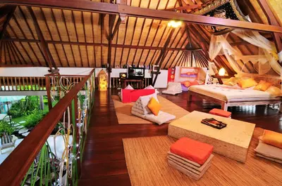 a room with a large room with couches and tables at Villa Domus De Janas in Seminyak