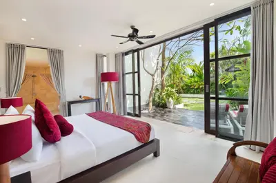 a bedroom with a large bed with red pillows at The Lookout Villa Jimbaran By Island Escape in Jimbaran