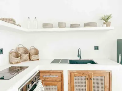 a kitchen with a sink and a counter with plates at Renovated 2BD Oasis with POOL - CasaEra in Seminyak main hub in Seminyak