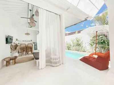 a living room with a pool and a dining room at Renovated 2BD Oasis with POOL - CasaEra in Seminyak main hub in Seminyak