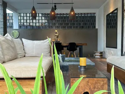a living room with a couch and a table at Solaris Private Villa Club Residence Canggu in Canggu