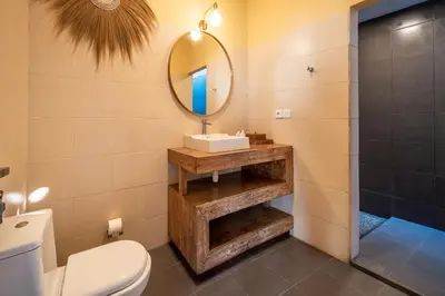 a bathroom with a sink and a mirror at 2 bedroom Balinese private pool villa in Seminyak in Seminyak