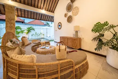 a living room with a rattan table and chairs at 2 bedroom Balinese private pool villa in Seminyak in Seminyak