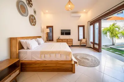 a bedroom with a bed and a television in it at 2 bedroom Balinese private pool villa in Seminyak in Seminyak