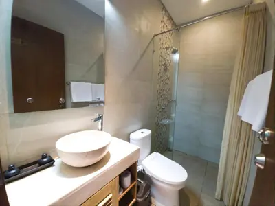 a bathroom with a sink and a toilet and a shower at Kamandaka in Kuta