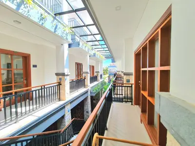an empty corridor of a building with a balcony at Kamandaka in Kuta