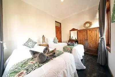 a bedroom with two beds with dogs laying on them at Villa MARIE - KUTA - 6 Bedroom 4 Bathroom Villa - Great Location ! in Kuta