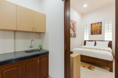 a kitchen with a bed and a sink in a room at Kubal Villa and Living Seminyak in Canggu